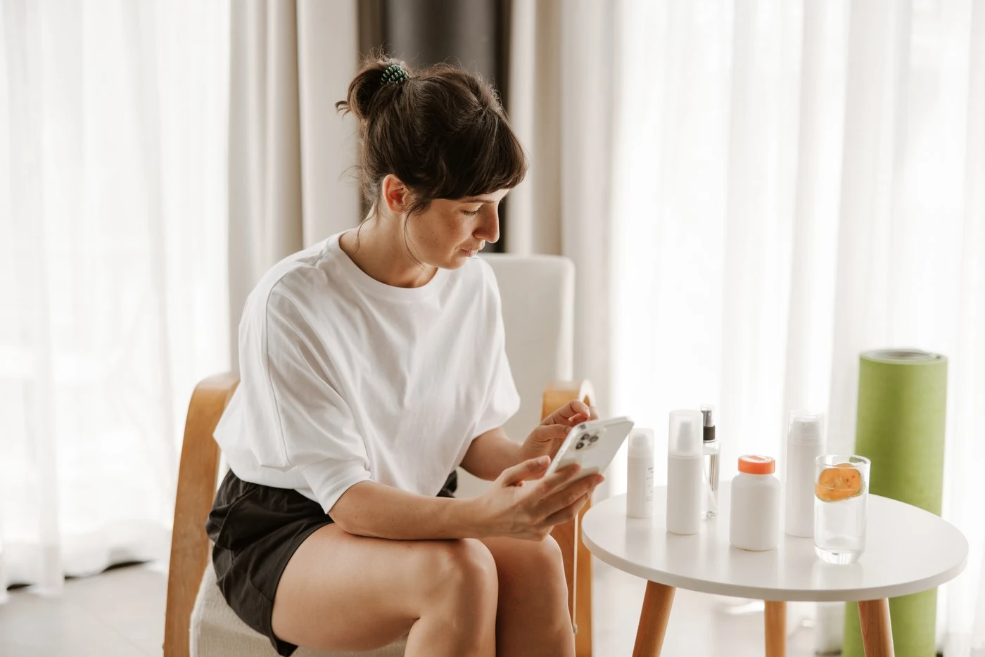 A practitioner pausing with her phone between sessions